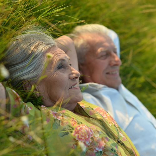 senior beautiful woman lying on grass