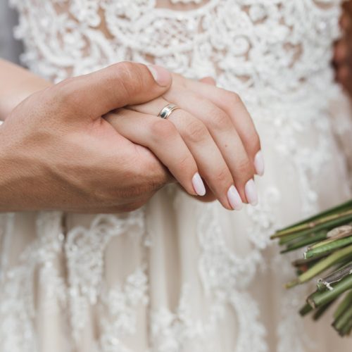Groom holds a bride for her hand
